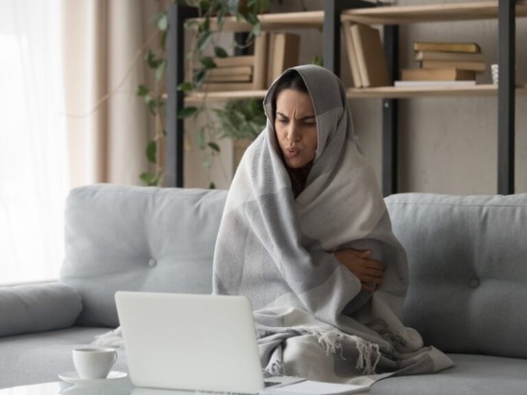 Cold Woman Looking At High Heating Bills